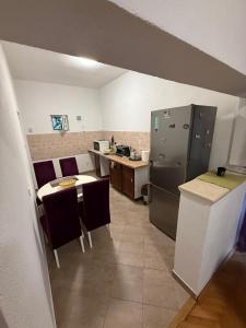 a kitchen with a refrigerator and a table and chairs at Old Town view apartment in Bar