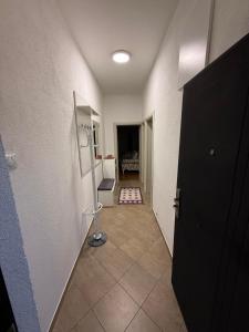 a hallway with a room with a door and a room with a table at Old Town view apartment in Bar
