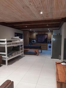 a living room with two bunk beds and a kitchen at Klein Plasie - St Helena Bay in Stompneusbaai