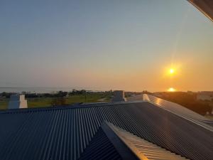 a view of the sunset from the roof of a building at Klein Plasie - St Helena Bay in Stompneusbaai