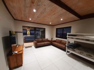 a living room with a couch and a television at Klein Plasie - St Helena Bay in Stompneusbaai