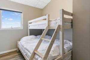 a bedroom with a bunk bed and a window at 839-Harboore-Strandvaenget-6 in Harboør
