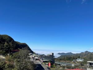 a street in a town with mountains in the background at Shan Da Ke Qi Min Su in Zhonghe