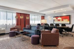 a living room filled with furniture and a piano at Garner Hotel Wadsworth by IHG in Wadsworth