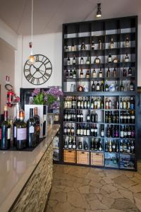 a store with a large display of bottles of wine at Albergo Colonna in Bertinoro