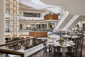 a restaurant with tables and chairs in a building at San Antonio Marriott Rivercenter on the River Walk in San Antonio