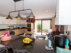 a kitchen with a table with a cake on it at Villa Séréna Pool and Comfy in Tamaris