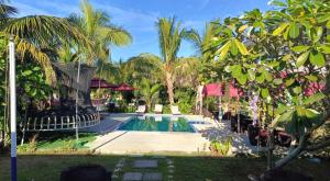 a resort with a swimming pool and palm trees at Nadi Fancy Hotel in Nadi