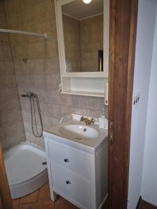 a bathroom with a sink and a tub and a toilet at Bajta 163 in Topusko +37 photos