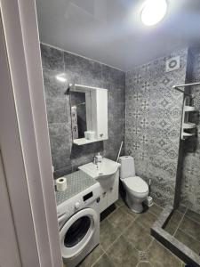 a bathroom with a toilet and a sink and a shower at bakuriani mix 504 in Bakuriani +9 photos