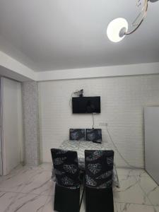 a room with a table and a tv on the wall at bakuriani mix 504 in Bakuriani