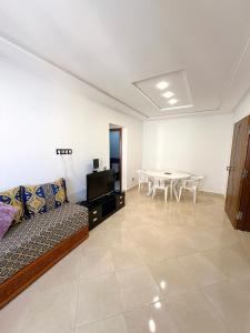 a living room with a couch and a table at Visit Chamal - Palmera 3 in Oued Laou