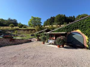 a house with a garage and a gravel driveway at Gite Marie Rose in Sainte-Marie-aux-Mines