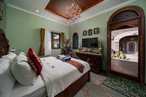 a bedroom with a large bed and a television at Puri Mayapada Nusa Dua Bali in Nusa Dua +48 photos