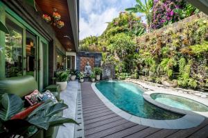 a swimming pool in the middle of a house at Puri Mayapada Nusa Dua Bali in Nusa Dua