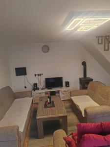 a living room with two couches and a table at Green Escape in Zavidovići