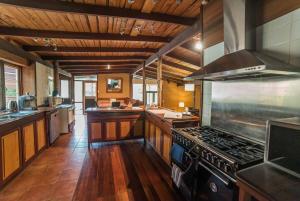 a large kitchen with a stove top oven at Eucalyptus House in Pemberton