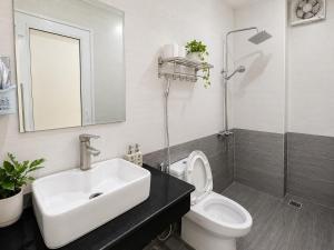 a white bathroom with a sink and a toilet at Funny Monkeys Homestay in Phong Nha +140 photos