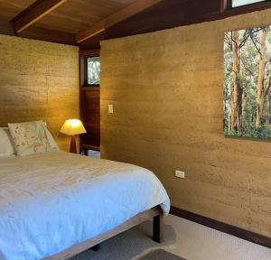 a bedroom with a bed and a window at Eucalyptus House in Pemberton