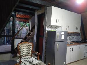 a kitchen with white cabinets and a refrigerator at Casa paula in San Agustín