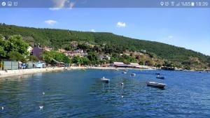 a group of boats in the water near a beach at Ocaklar Torunlar Apart in Erdek +17 photos