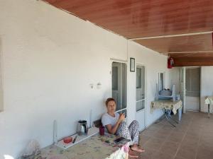 a woman sitting on a table in a room at Ocaklar Torunlar Apart in Erdek