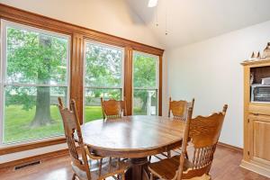 a dining room with a wooden table and chairs at Kaw Drive Guest House in Olathe