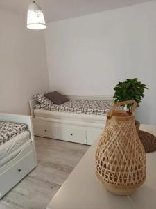 a room with a bed and a table with a bag at Apartament łeba in Żarnowska +7 photos
