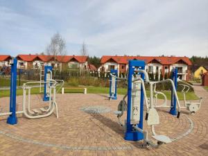 a group of exercise equipment in a park at Apartament łeba in Żarnowska