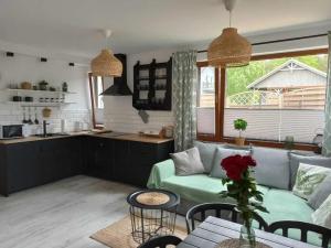 a living room with a couch and a table at Apartament łeba in Żarnowska