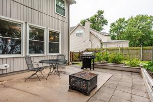 a patio with a table and chairs next to a house at Kaw Drive Guest House in Olathe