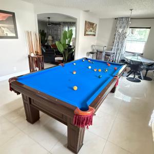 a pool table in the middle of a living room at Luxury and Comfort in Coconut Creek +7 photos