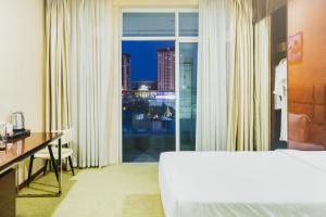 a hotel room with a bed and a view of a city at Diamond Pearl Hotel ,Phnom Penh,Royel Palace, Mekong RIver,Swimming Pool in Phnom Penh +49 photos