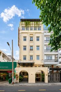 an apartment building with an archway in front of it at Cactusland Hotel Tan Binh Near T3 Station in Ho Chi Minh City