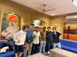 a group of men posing for a picture in a room at Musafir Desert Camp Jaisalmer in Jaisalmer