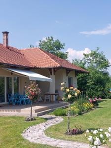 a house with a garden with flowers and a pathway at 3a kuca Bajevac in Bajevac