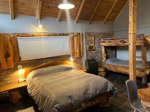 a bedroom with two bunk beds and a table at Bolson deptos in El Bolsón