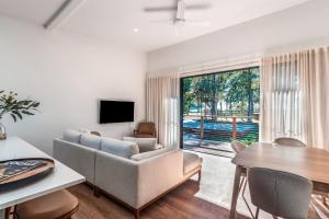 a living room with a couch and a table at Fernleigh Stay in Fernleigh