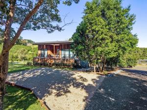 an exterior view of a home with a tree at Fernleigh Stay in Fernleigh