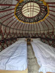 a large bed in a room with a ceiling at Altyn Sky in Mineralʼnyy Istochnik Altyn-Arasan
