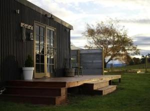 a wooden deck on the side of a house at The Milkmans Shack in Dunorlan