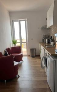 a kitchen with a couch and a chair in a room at B&B Yle in Cetraro