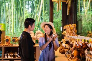 a man and a woman looking at stuffed animals at HuzhouGiraffe ManorHotel in Huzhou +98 photos