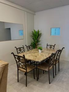 a dining room with a table and chairs at Golden Isles Paradise in Port-of-Spain