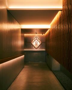 a hallway with a light projected on the wall at hotel androoms Kyoto Shichijo in Kyoto