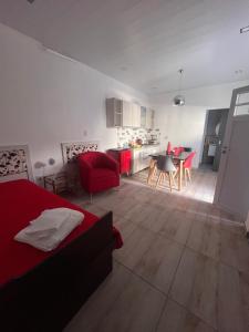 a living room with a red bed and a kitchen at Temporario Martínez in General Pico +34 photos