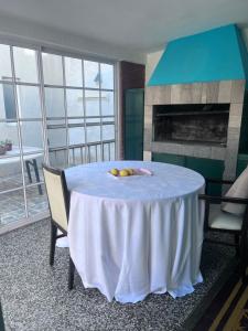 a dining room with a table and a fireplace at Temporario Martínez in General Pico