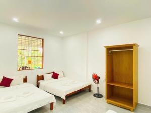 a room with two beds and a window at Boho NHH Apartment in Hanoi