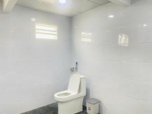 a white bathroom with a toilet in a room at Boho NHH Apartment in Hanoi