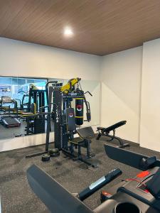 a gym with several tread machines and a mirror at Azana Boutique Hotel Solo in Purwosari